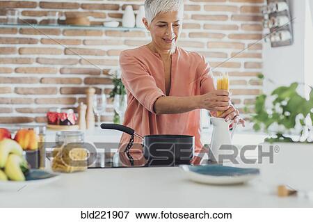 Older Caucasian woman cooking spaghetti in kitchen View Large Photo Image Stock Photo - Older Caucasian woman cooking spaghetti in kitchen. Fotosearch