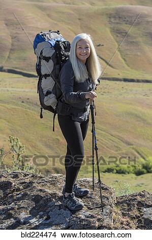 Picture - Older Caucasian woman hiking with backpack. Fotosearch