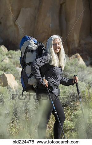 Older Caucasian woman hiking with backpack View Large Photo Image Stock Photo - Older Caucasian woman hiking with backpack. Fotosearch