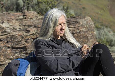 Older Caucasian woman leaning on rock writing in journal View Large Photo Image Stock Photo - Older Caucasian woman leaning on rock writing in journal. Fotosearch