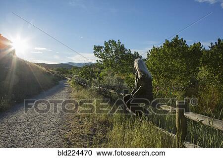 Older Caucasian woman sitting on wooden fence near mountain View Large Photo Image Stock Image - Older Caucasian woman sitting on wooden fence near mountain. Fotosearch