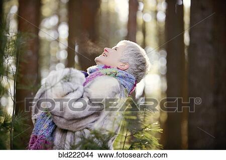 Older Caucasian woman standing outdoors View Large Photo Image Picture - Older Caucasian woman standing outdoors. Fotosearch