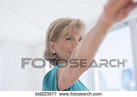 Stock Photo - Older Caucasian woman with arms outstretched. Fotosearch