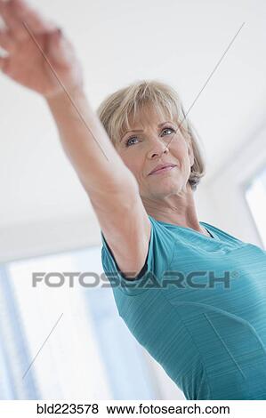 Stock Photo - Older Caucasian woman with arms outstretched. Fotosearch