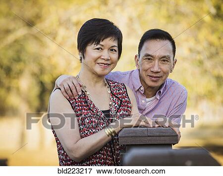 Stock Photo - Older Chinese couple smiling outdoors. Fotosearch