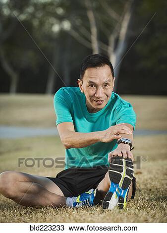Older Chinese man stretching in park View Large Photo Image Stock Image - Older Chinese man stretching in park. Fotosearch