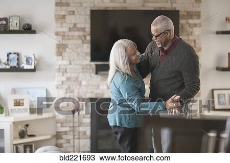 Older couple dancing in living room View Large Photo Image Stock Image - Older couple dancing in living room. Fotosearch