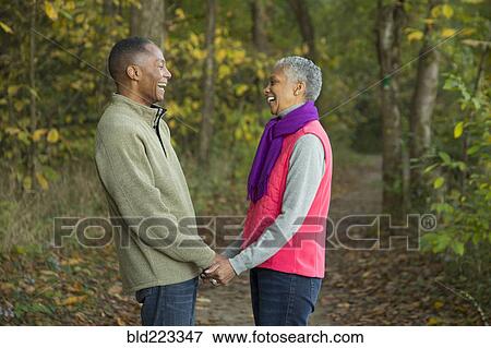 Older couple holding hands in forest View Large Photo Image Stock Photo - Older couple holding hands in forest. Fotosearch