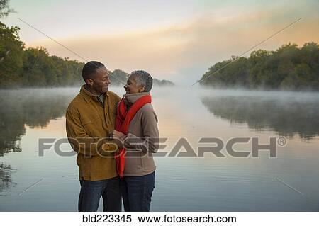 Older couple hugging at foggy river at sunrise View Large Photo Image Stock Photography - Older couple hugging at foggy river at sunrise. Fotosearch