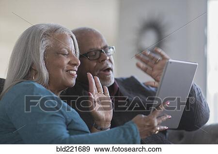 Older couple video chatting with digital tablet View Large Photo Image Stock Photo - Older couple video chatting with digital tablet. Fotosearch