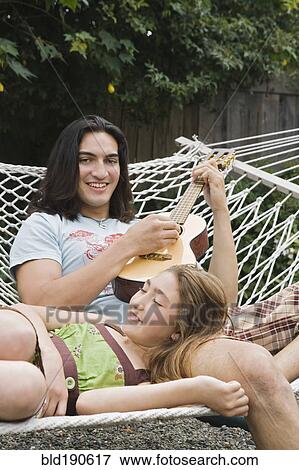 Pacific Islander man playing ukulele for sister View Large Photo Image Stock Photo - Pacific Islander man playing ukulele for sister. Fotosearch