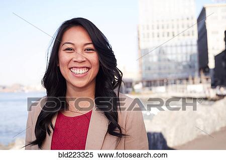 Stock Photography - Pacific Islander woman smiling at waterfront. Fotosearch