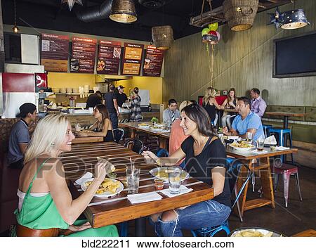 Stock Image - People eating in cafe. Fotosearch