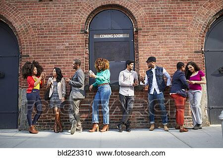 People waiting in line at theater using cell phones View Large Photo Image Stock Image - People waiting in line at theater using cell phones. Fotosearch