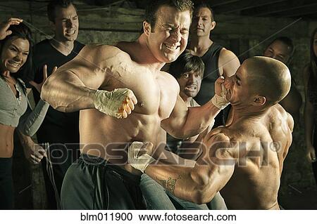 Stock Image - People watching two men boxing without gloves. Fotosearch