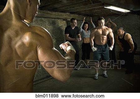 Stock Photo - People watching two men boxing without gloves. Fotosearch