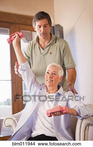 Physical therapist helping woman with exercises View Large Photo Image Picture - Physical therapist helping woman with exercises. Fotosearch