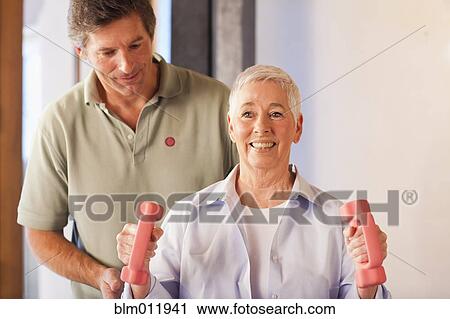 Physical therapist helping woman with exercises View Large Photo Image Stock Image - Physical therapist helping woman with exercises. Fotosearch