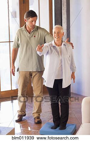 Physical therapist helping woman with exercises View Large Photo Image Stock Photo - Physical therapist helping woman with exercises. Fotosearch