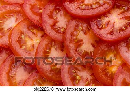 Stock Photo - Pile of sliced red tomatoes. Fotosearch