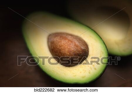 Stock Image - Pit in sliced avocado. Fotosearch