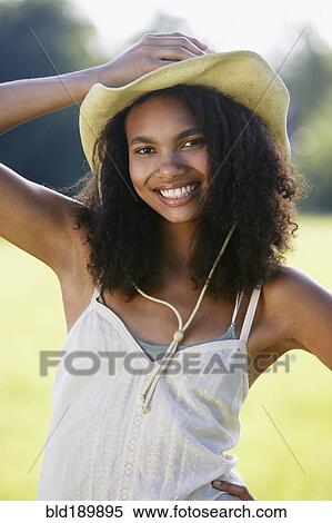 Portrait of African woman wearing straw hat outdoors View Large Photo Image Stock Photography - Portrait of African woman wearing straw hat outdoors. Fotosearch