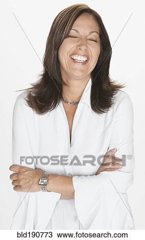 Stock Image - Portrait of Hispanic woman laughing with eyes closed. Fotosearch