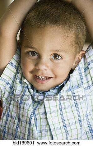 Stock Image - Portrait of smiling mixed race boy. Fotosearch