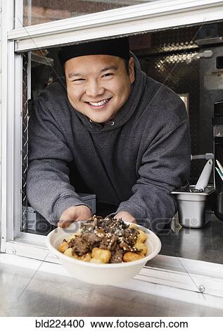 Proud Asian man showing bowl of food at food truck View Large Photo Image Stock Image - Proud Asian man showing bowl of food at food truck. Fotosearch
