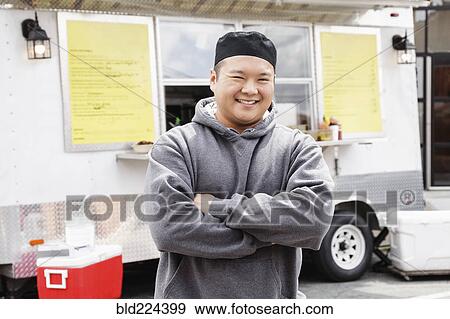Proud Asian man standing at food truck View Large Photo Image Stock Photo - Proud Asian man standing at food truck. Fotosearch