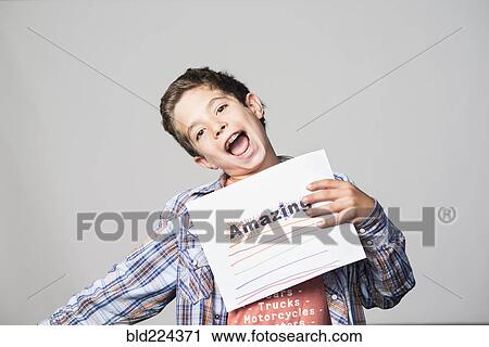 Proud Mixed Race boy holding awesome sign View Large Photo Image Stock Image - Proud Mixed Race boy holding awesome sign. Fotosearch