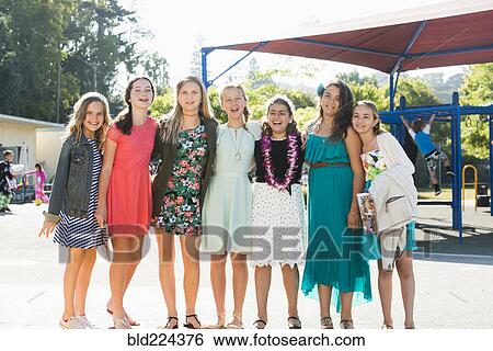 Stock Photograph - Proud well-dressed girls posing on playground. Fotosearch