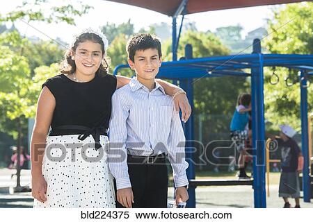 Proud well-dressed Mixed Race brother and sister posing on playground View Large Photo Image Stock Photography - Proud well-dressed Mixed Race brother and sister posing on playground. Fotosearch