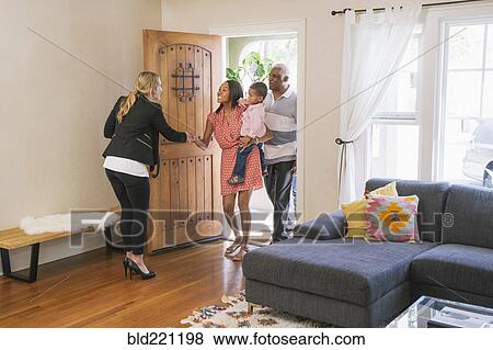 Real estate agent showing house to clients View Large Photo Image Stock Photo - Real estate agent showing house to clients. Fotosearch
