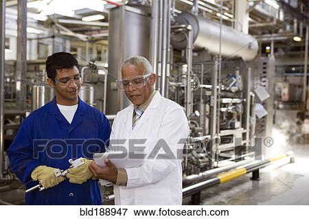 Scientist talking to factory worker View Large Photo Image Stock Photo - Scientist talking to factory worker. Fotosearch
