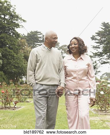 Senior African couple holding hands and walking outdoors View Large Photo Image Stock Image - Senior African couple holding hands and walking outdoors. Fotosearch