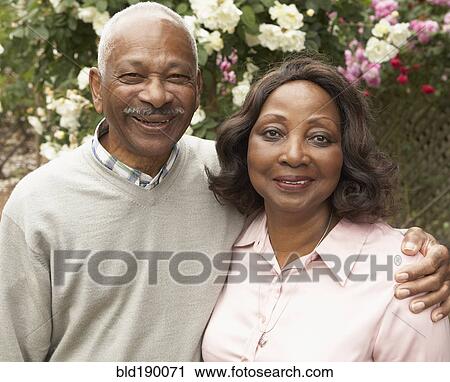 Senior African couple hugging and smiling outdoors View Large Photo Image Stock Image - Senior African couple hugging and smiling outdoors. Fotosearch