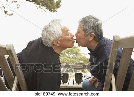 Senior Asian couple kissing outdoors View Large Photo Image Stock Photo - Senior Asian couple kissing outdoors. Fotosearch