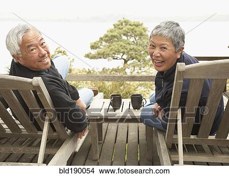 Senior Asian couple smiling outdoors View Large Photo Image Picture - Senior Asian couple smiling outdoors. Fotosearch
