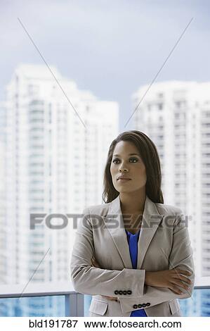 Stock Photo - Serious African businesswoman on urban balcony. Fotosearch