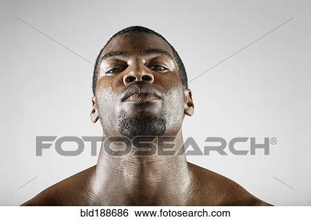 Stock Photograph - Serious African man sweating. Fotosearch