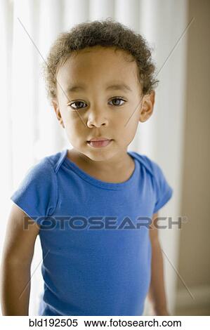 Stock Photography - Serious mixed race young boy. Fotosearch