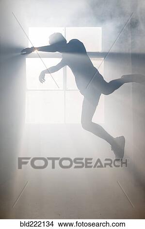 Picture - Shadow of Caucasian man at window. Fotosearch