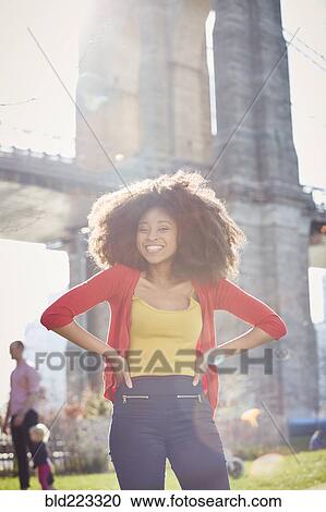 Smiling Black woman posing with hands on hips View Large Photo Image Stock Image - Smiling Black woman posing with hands on hips. Fotosearch