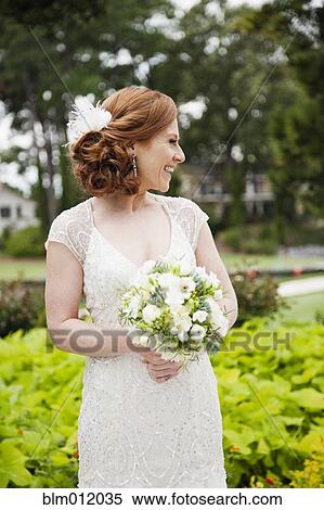 Smiling Caucasian bride holding wedding bouquet View Large Photo Image Stock Photography - Smiling Caucasian bride holding wedding bouquet. Fotosearch