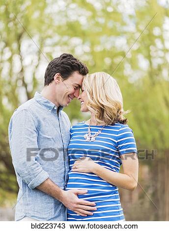 Smiling Caucasian man and expectant mother rubbing noses View Large Photo Image Stock Image - Smiling Caucasian man and expectant mother rubbing noses. Fotosearch
