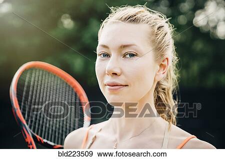 Smiling Caucasian woman holding tennis racket View Large Photo Image Stock Photo - Smiling Caucasian woman holding tennis racket. Fotosearch