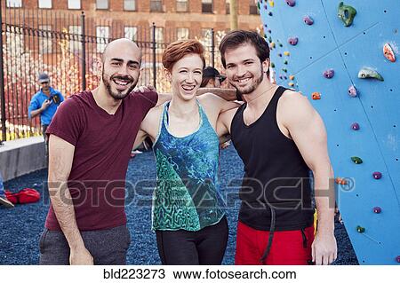 Smiling friends posing at outdoor climbing wall View Large Photo Image Stock Image - Smiling friends posing at outdoor climbing wall. Fotosearch