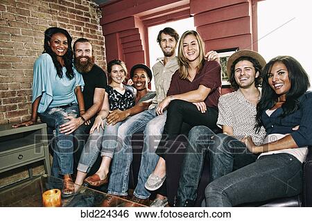Stock Photograph - Smiling friends posing in bar. Fotosearch