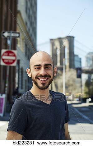 Smiling Hispanic man in city View Large Photo Image Stock Image - Smiling Hispanic man in city. Fotosearch